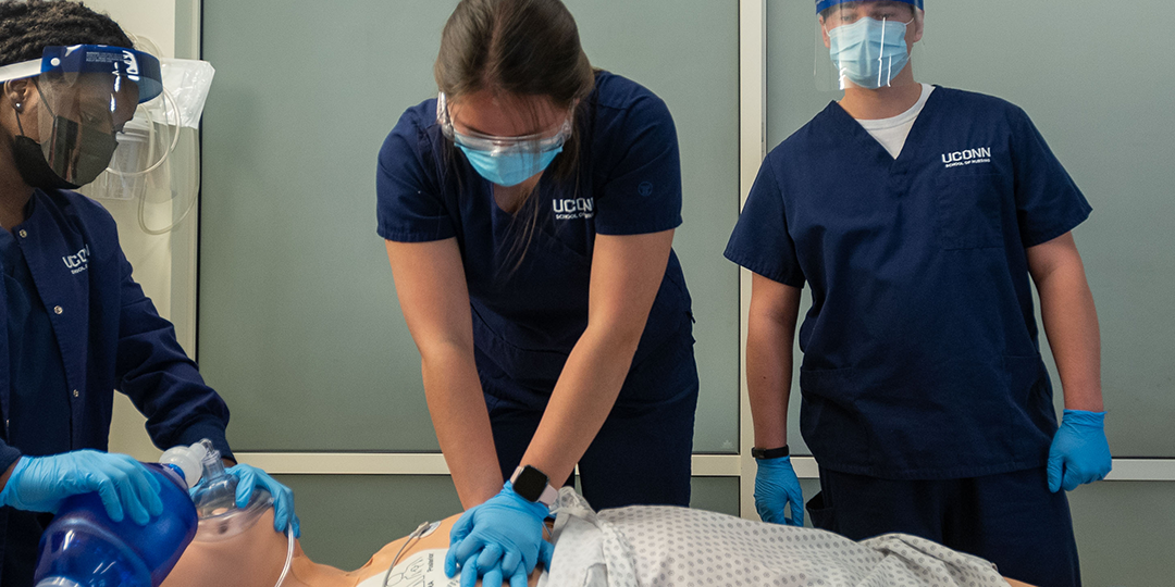 Students practice CPR on a manikin